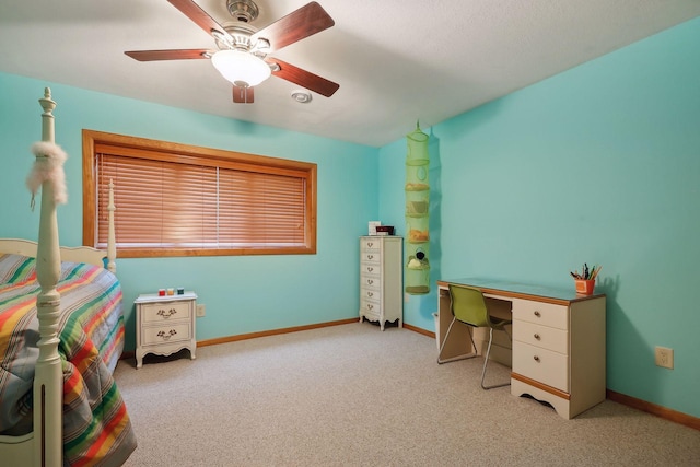 carpeted office space with ceiling fan