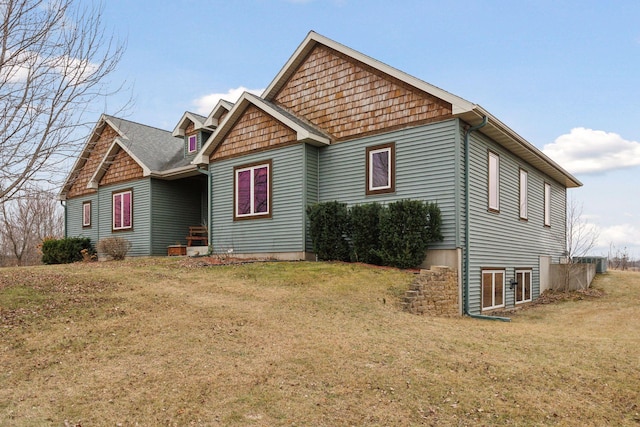 view of side of home with a yard