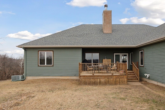 rear view of property with a yard, a deck, and central AC unit