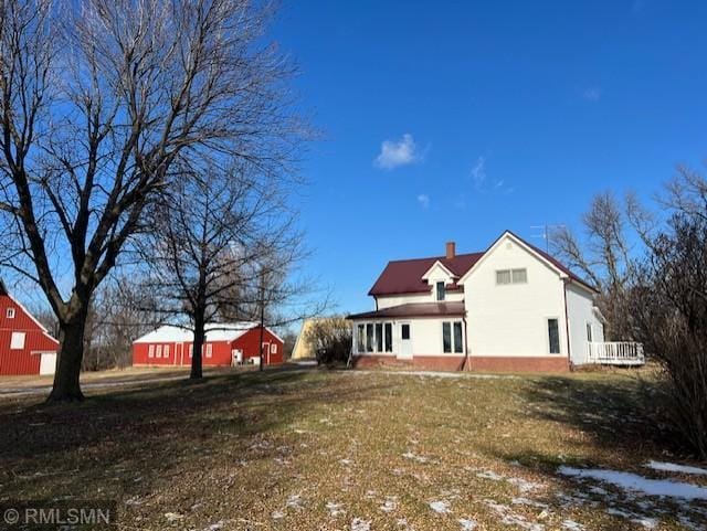 back of property with a yard