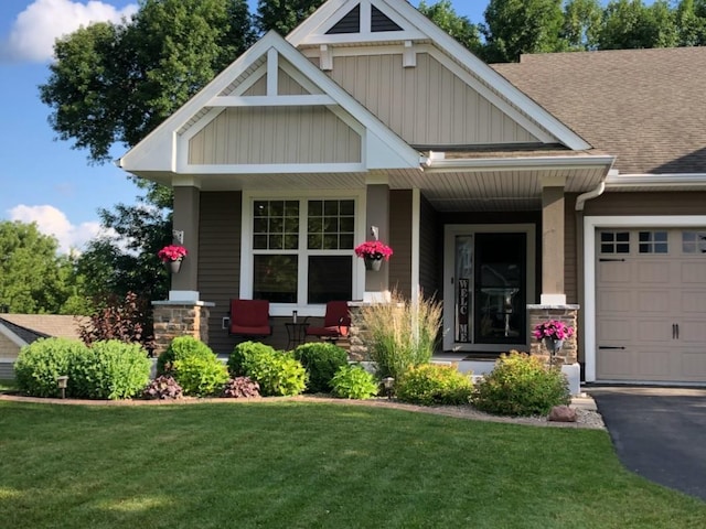 craftsman house with covered porch and a front yard