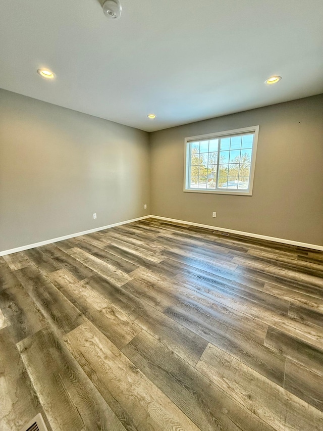 spare room featuring dark wood-type flooring