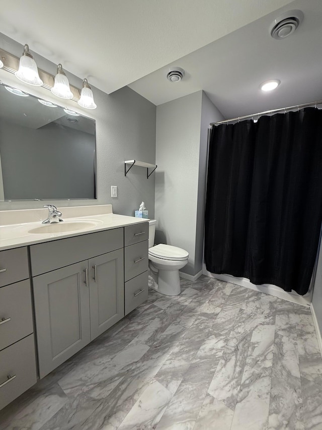 bathroom with vanity and toilet