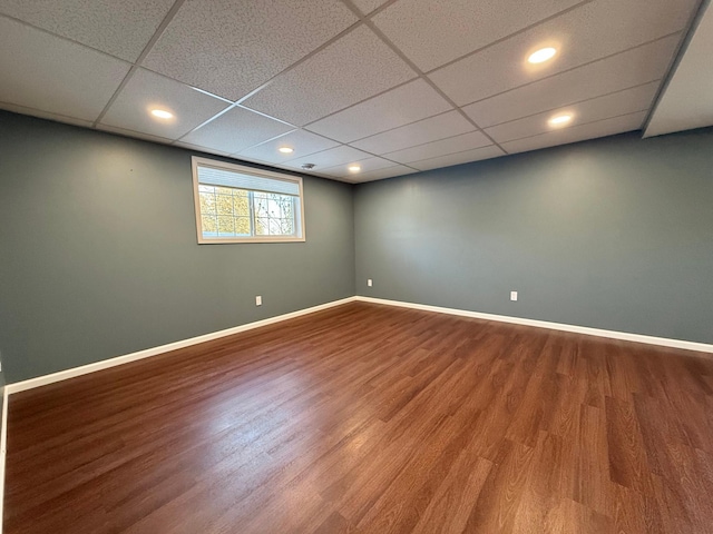 empty room featuring hardwood / wood-style floors and a paneled ceiling