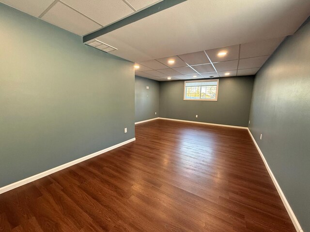 unfurnished room featuring a paneled ceiling and hardwood / wood-style floors