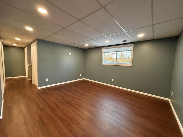 basement featuring hardwood / wood-style floors and a drop ceiling