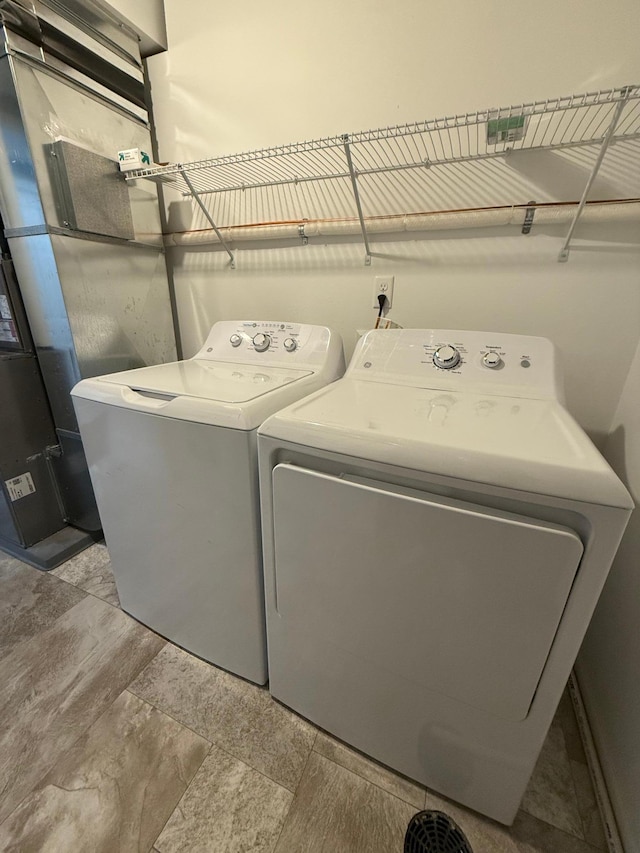 clothes washing area featuring separate washer and dryer