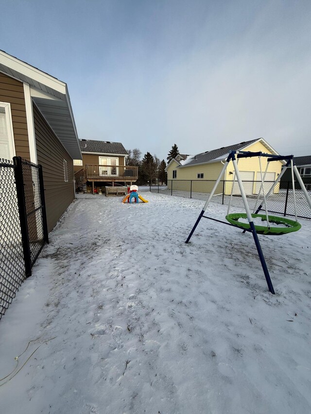 view of yard with a wooden deck and a playground