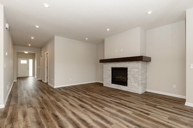 unfurnished living room with a fireplace and dark hardwood / wood-style floors