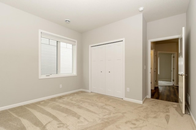 unfurnished bedroom with carpet floors and a closet