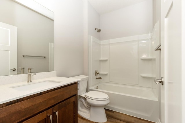 full bathroom with vanity, hardwood / wood-style floors, shower / bathtub combination, and toilet