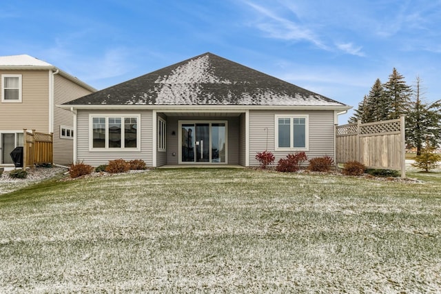 rear view of house featuring a yard