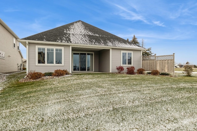 rear view of property featuring a lawn