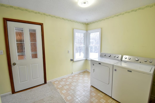 laundry room with washer and clothes dryer and a textured ceiling