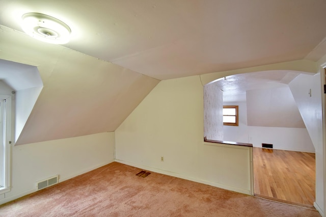 bonus room with carpet and vaulted ceiling