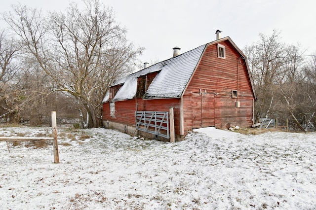 view of snowy exterior with an outdoor structure