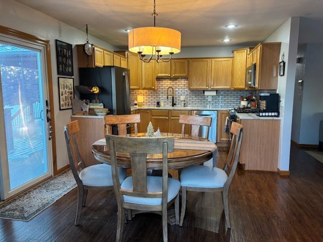 dining room with sink and dark wood-type flooring