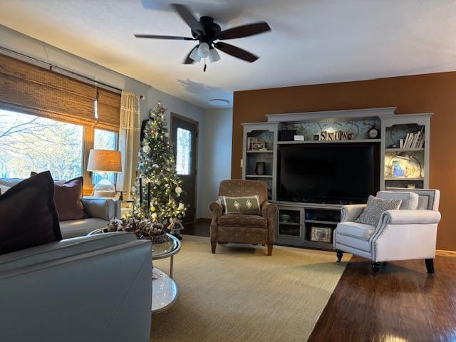 living room with hardwood / wood-style floors and ceiling fan