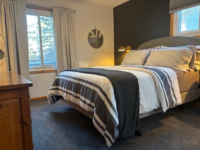 bedroom featuring dark colored carpet