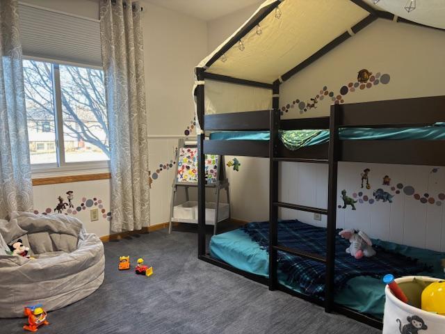 bedroom featuring carpet floors and lofted ceiling