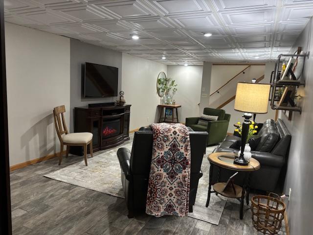 living room with dark hardwood / wood-style floors and a fireplace