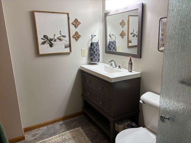 bathroom featuring hardwood / wood-style floors, vanity, and toilet