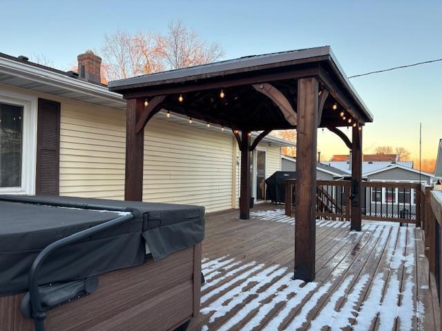 snow covered deck featuring grilling area