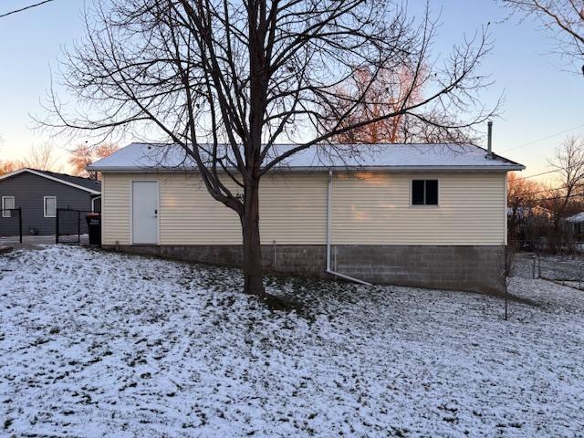 view of snow covered back of property