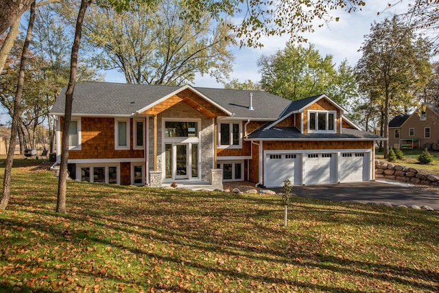 raised ranch with a garage and a front yard