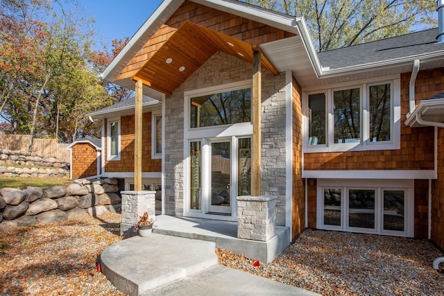 5517 Dickson Rd, Minnetonka, MN 55345 - view of exterior entry with stone siding and roof with shingles