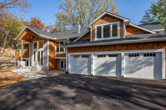 5517 Dickson Rd, Minnetonka, MN 55345 - view of front of home with a shingled roof, asphalt driveway, and an attached garage