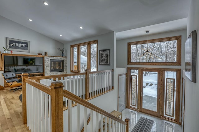 5517 Dickson Rd, Minnetonka, MN 55345 - entryway with vaulted ceiling, recessed lighting, a fireplace, and light wood-style floors