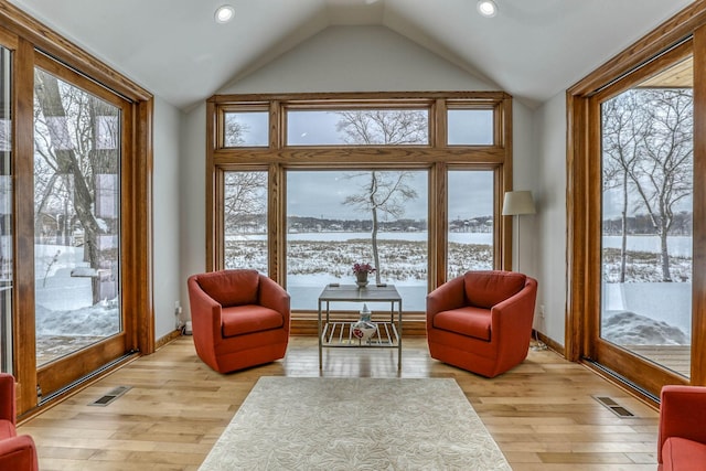 5517 Dickson Rd, Minnetonka, MN 55345 - living area featuring lofted ceiling, light wood-style floors, recessed lighting, baseboards, and a water view