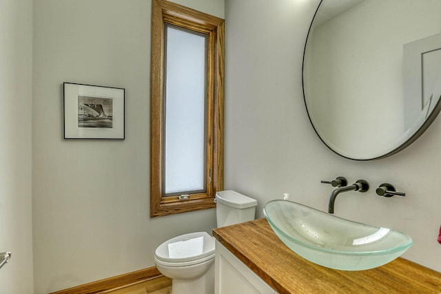 5517 Dickson Rd, Minnetonka, MN 55345 - bathroom featuring vanity, toilet, and wood finished floors