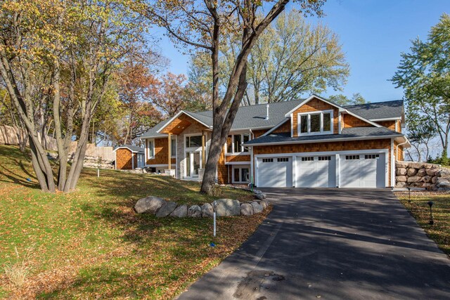 5517 Dickson Rd, Minnetonka, MN 55345 - view of front facade with asphalt driveway, a front yard, and roof with shingles