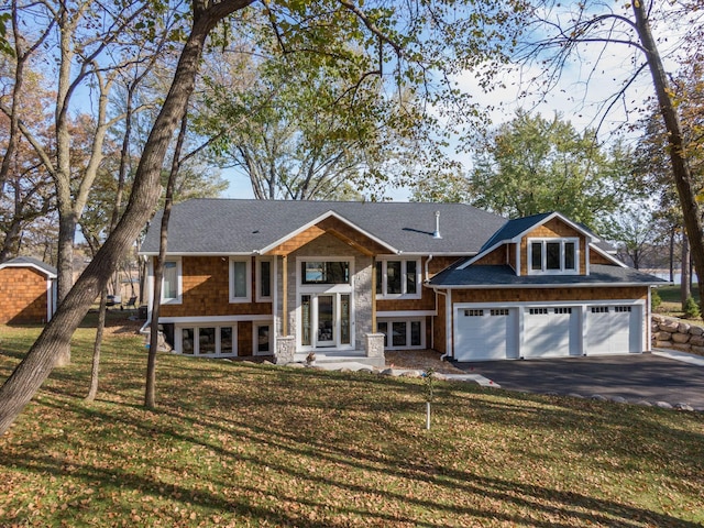 5517 Dickson Rd, Minnetonka, MN 55345 - view of front of property with asphalt driveway, a front yard, stone siding, a shingled roof, and french doors