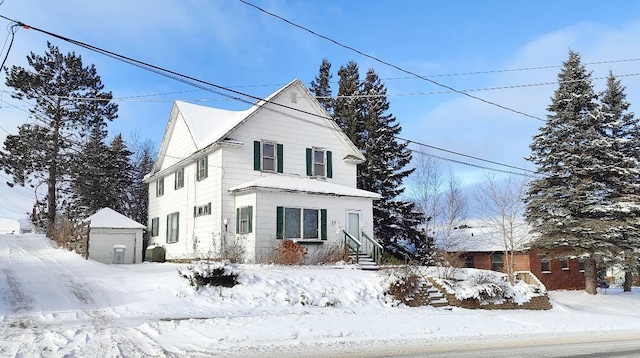 view of front of property featuring an outbuilding and a garage