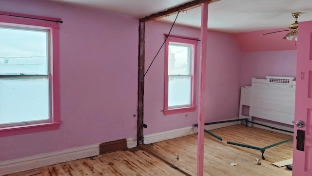 additional living space featuring ceiling fan, lofted ceiling, and light wood-type flooring