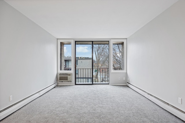 spare room featuring a wall mounted air conditioner, carpet floors, and a baseboard heating unit