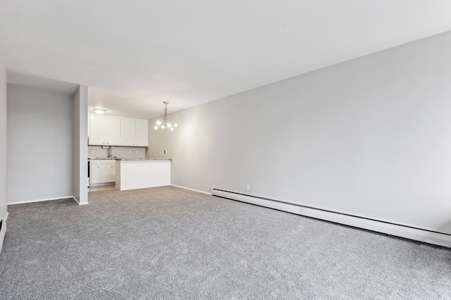 unfurnished living room with carpet, a notable chandelier, and a baseboard radiator