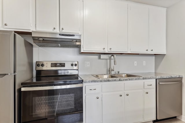 kitchen with appliances with stainless steel finishes, white cabinetry, and sink