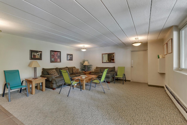 living room featuring carpet flooring, a textured ceiling, and a baseboard heating unit