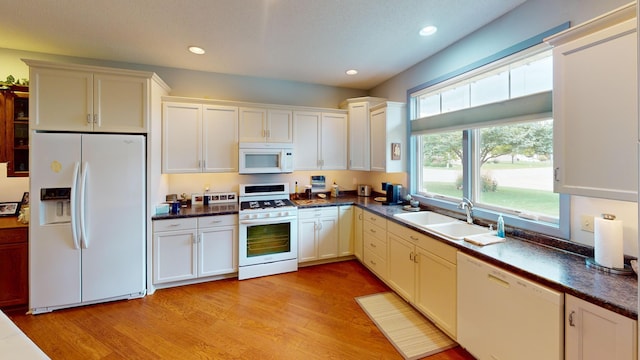 kitchen featuring light hardwood / wood-style floors, white appliances, sink, and white cabinetry