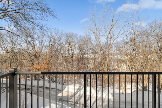 view of snow covered back of property