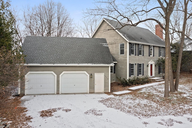 colonial inspired home with a garage