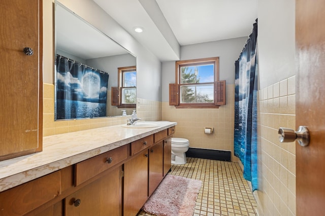 full bathroom featuring a wainscoted wall, toilet, tile walls, curtained shower, and vanity