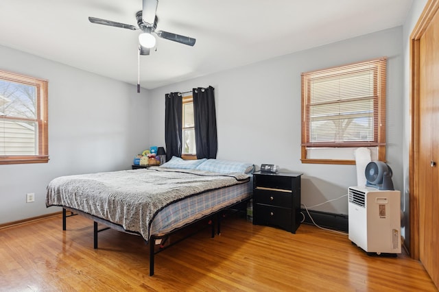 620 8th St SW, Faribault, MN 55021 - bedroom with light wood finished floors, baseboards, a ceiling fan, and a closet