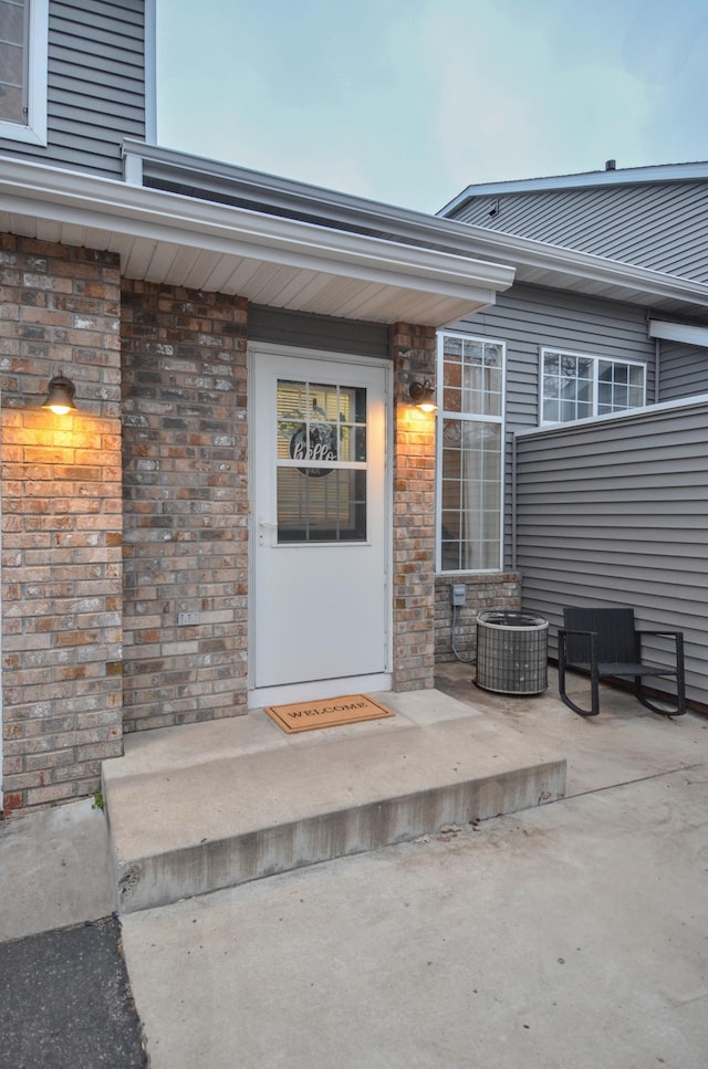 property entrance featuring a patio and central AC