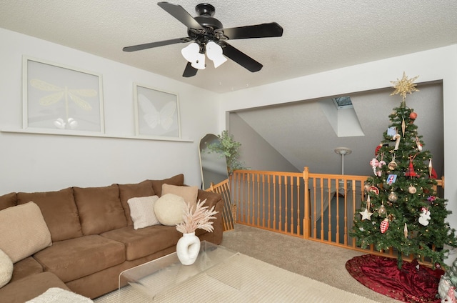 carpeted living room featuring a textured ceiling and ceiling fan