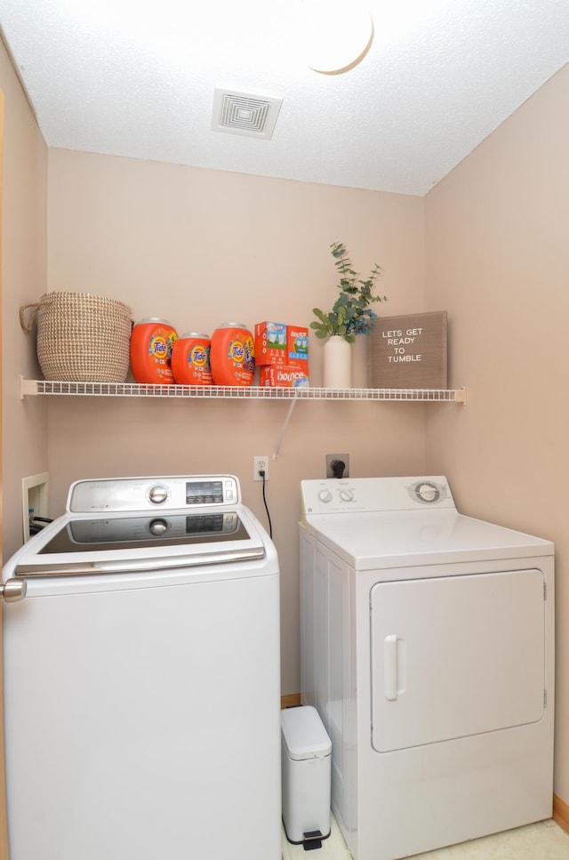 clothes washing area with washer and dryer